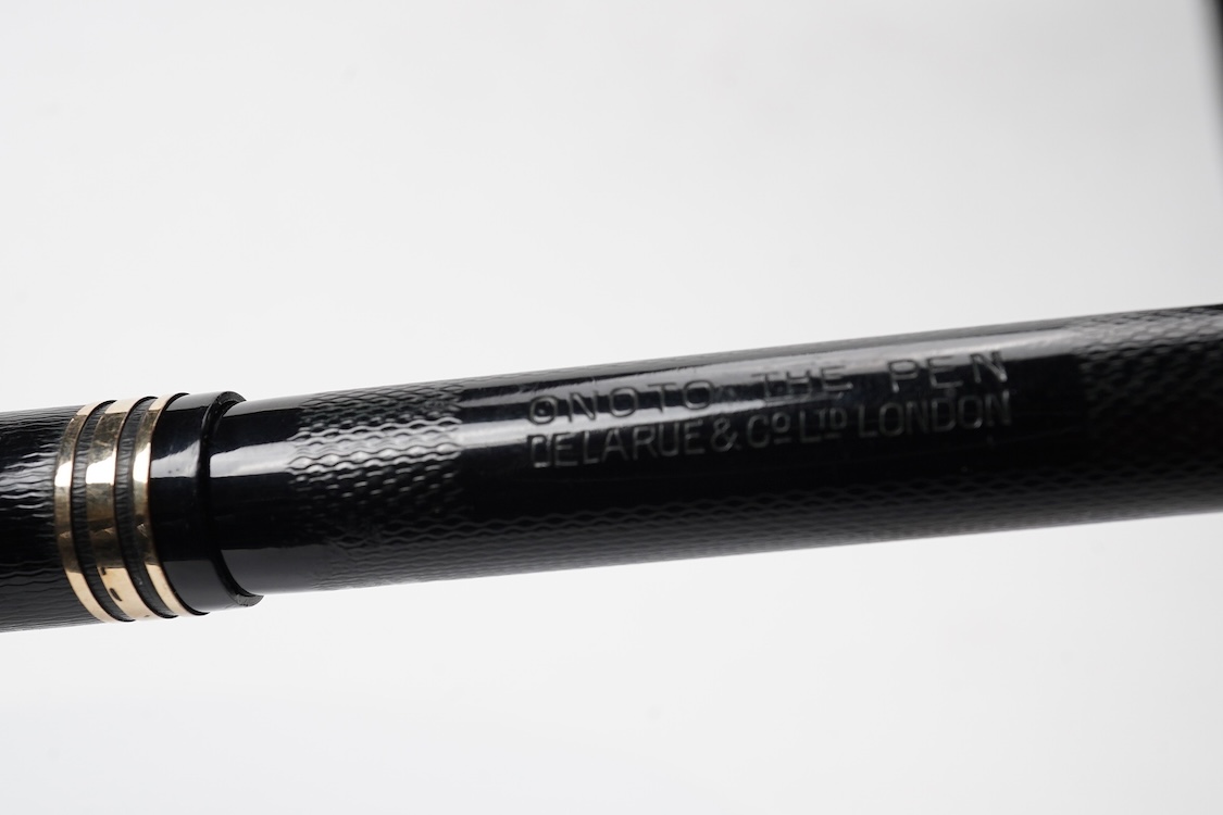 A De la Rue Onoto piston fill fountain pen in large size with ornate cap banding and fitted with DLR Onoto No.5 14ct. nib